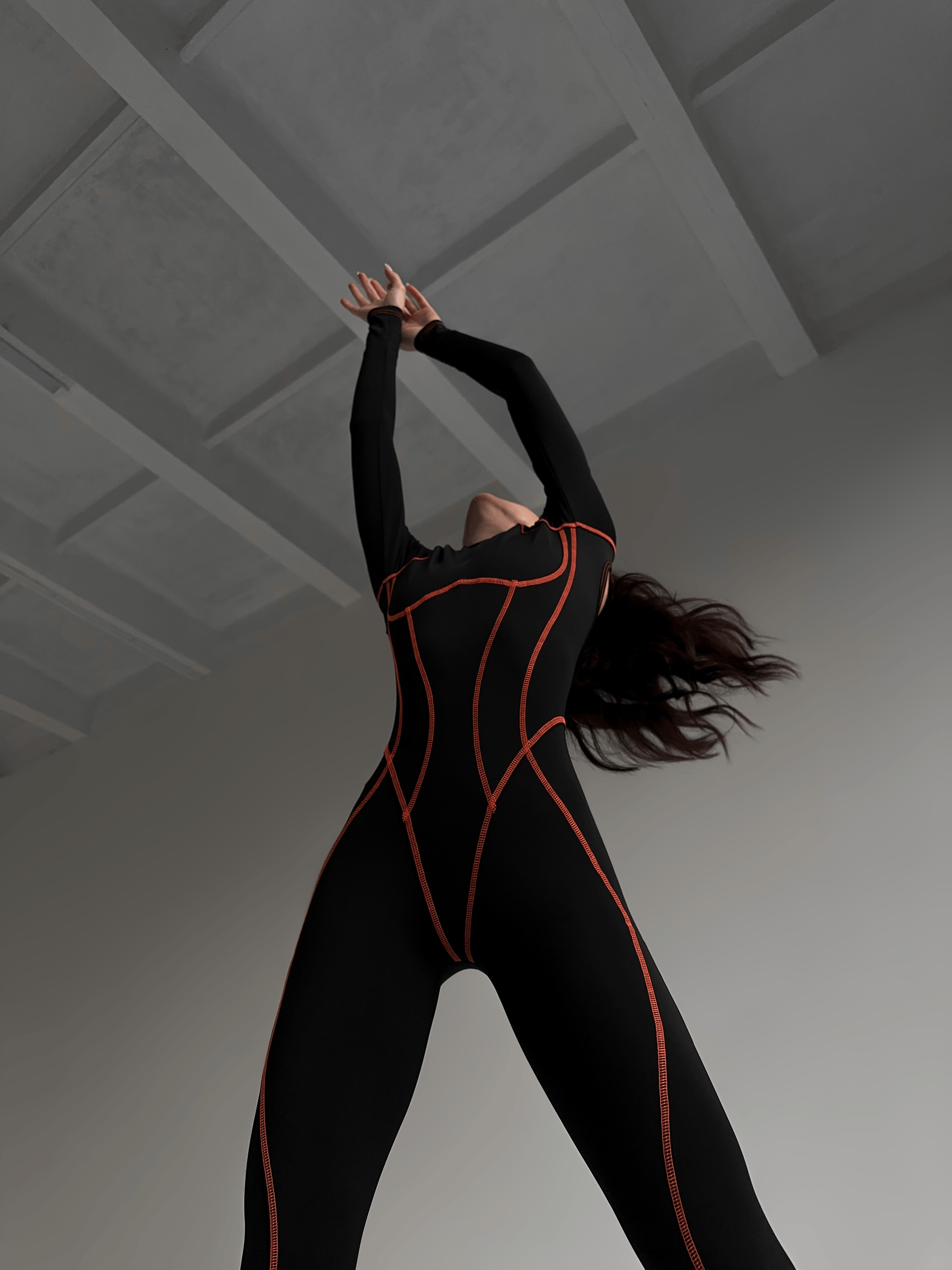 Galaxy Contour Seam Open Back Long Sleeve Jumpsuit in Black and Neon Orange