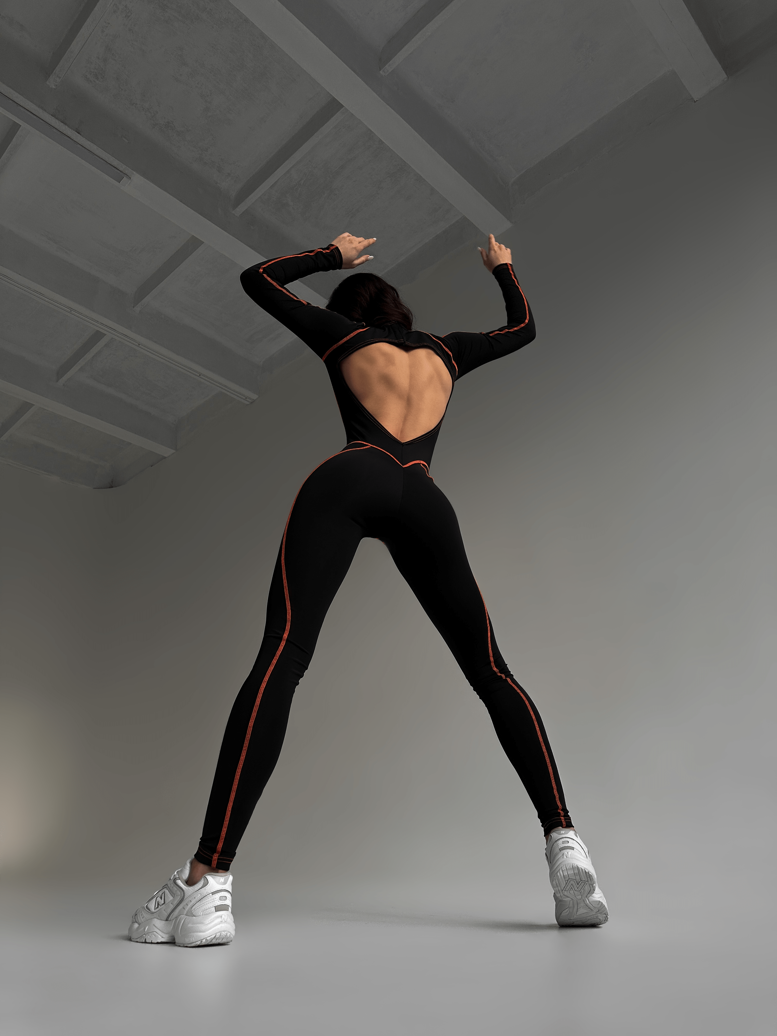 Galaxy Contour Seam Open Back Long Sleeve Jumpsuit in Black and Neon Orange