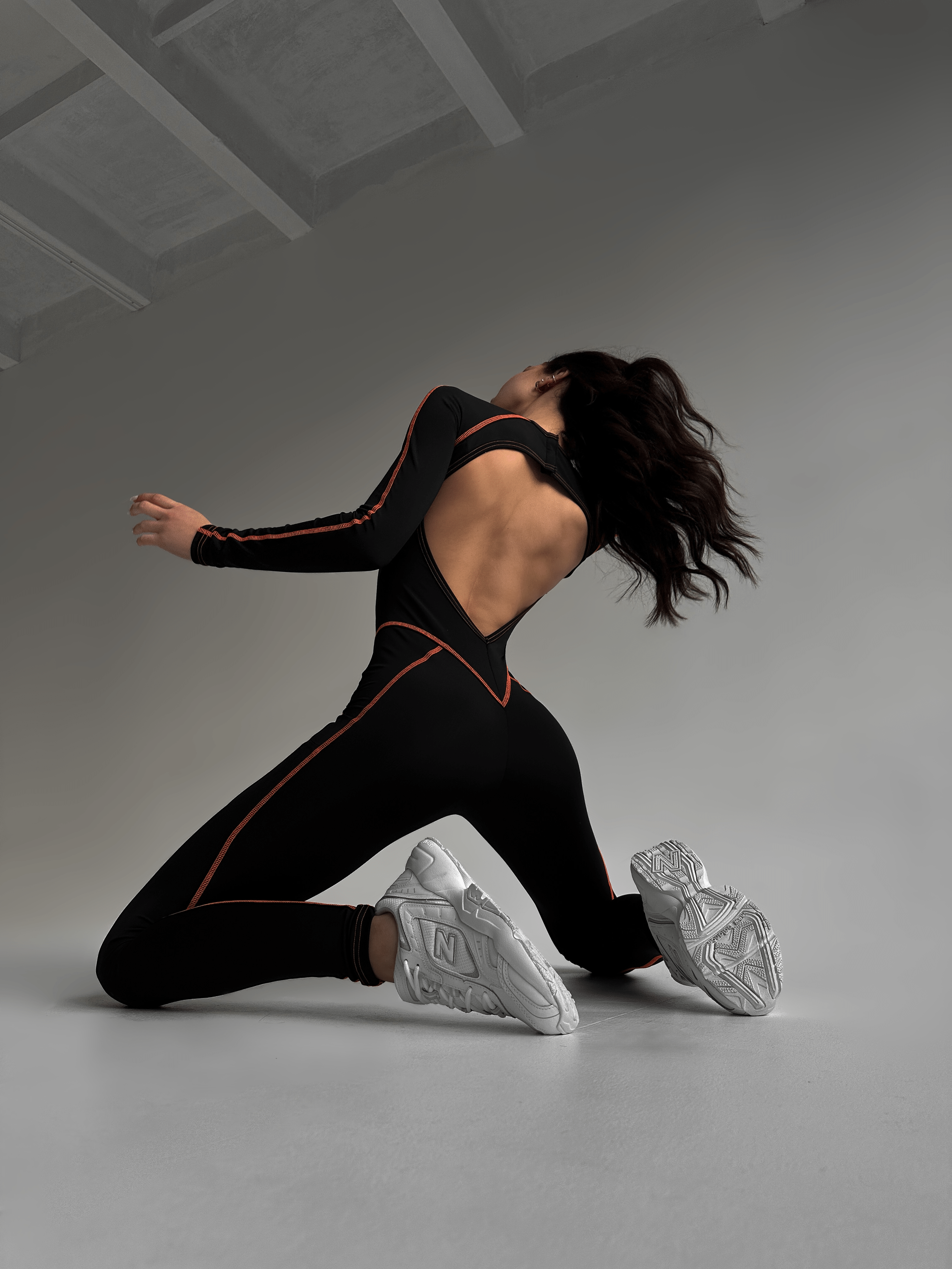 Galaxy Contour Seam Open Back Long Sleeve Jumpsuit in Black and Neon Orange