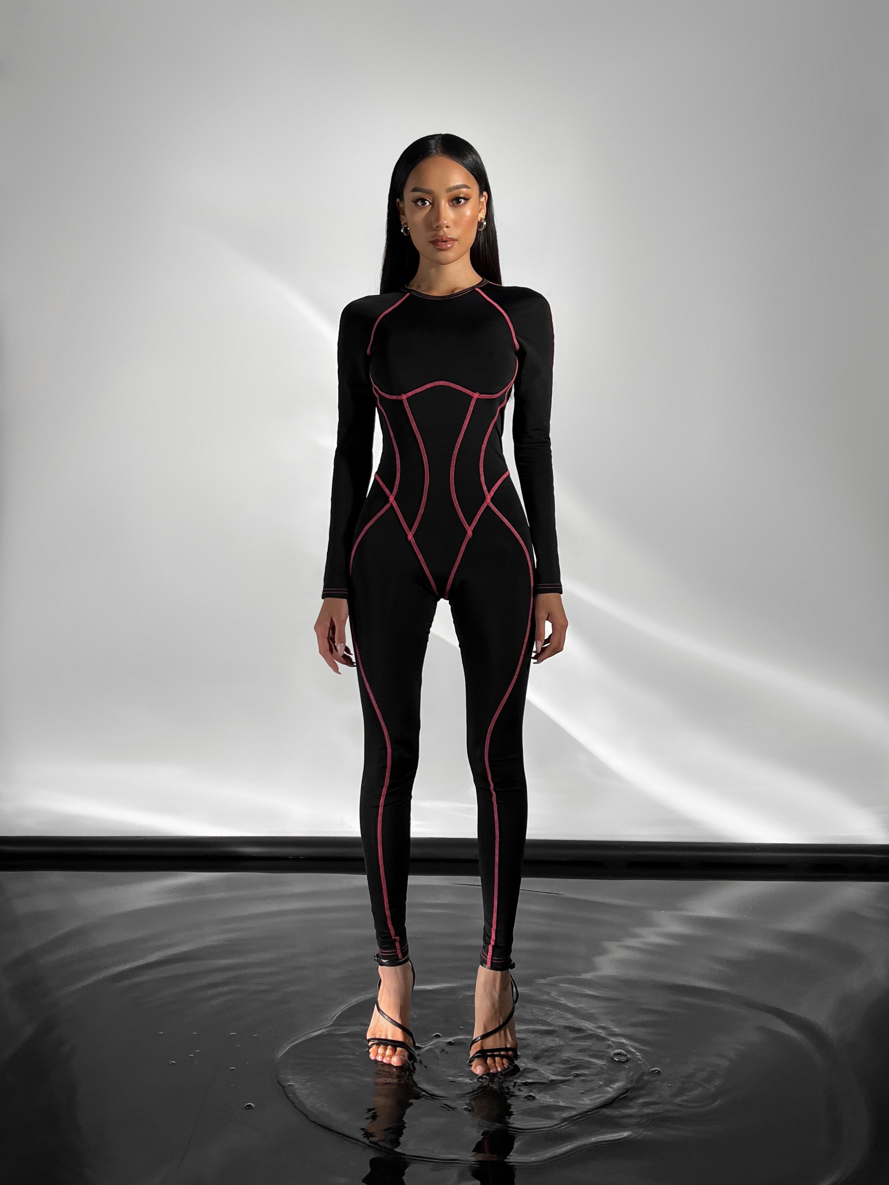 Galaxy Contour Seam Open Back Long Sleeve Jumpsuit in Black and Neon Pink