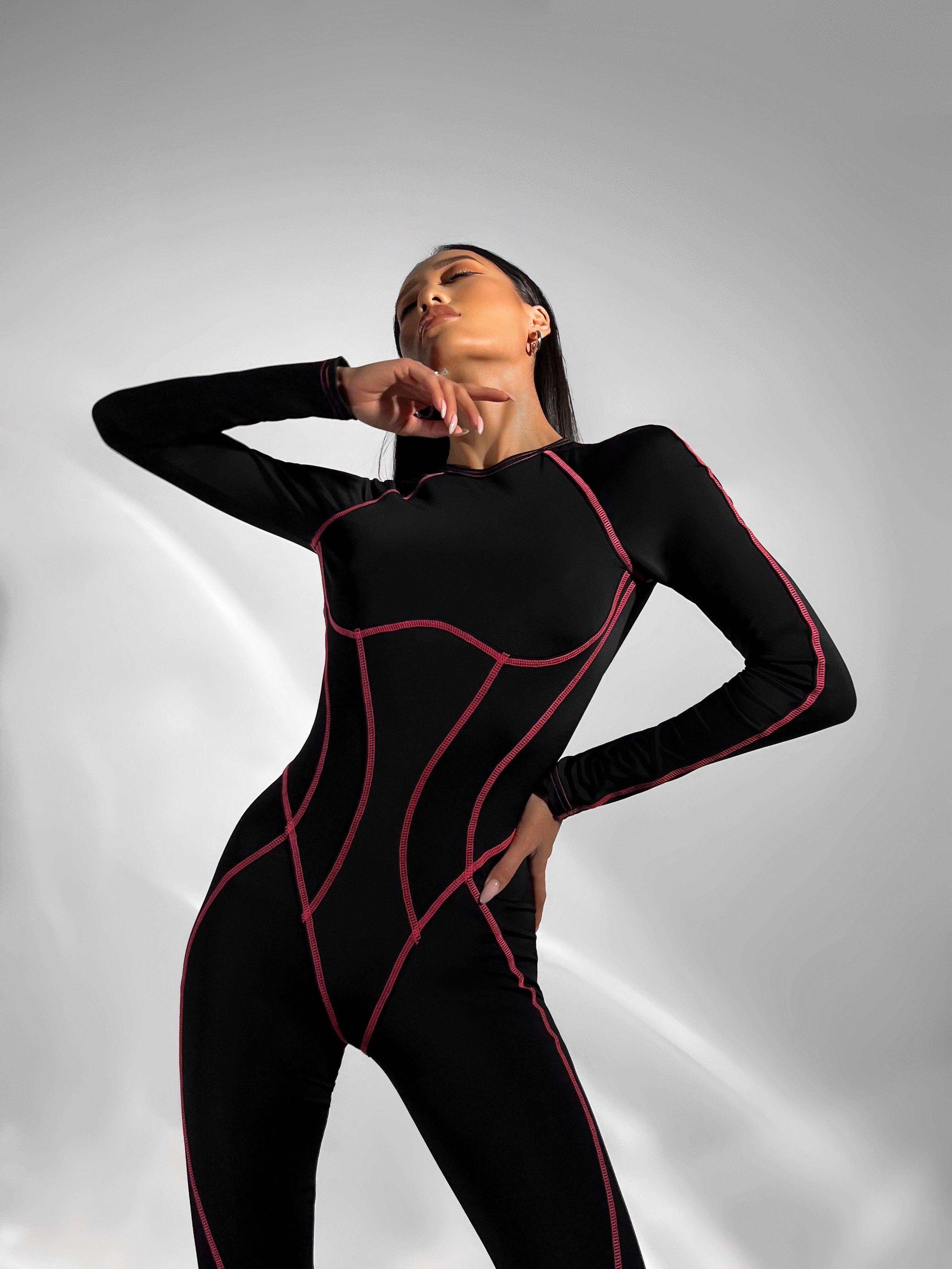 Galaxy Contour Seam Open Back Long Sleeve Jumpsuit in Black and Neon Pink